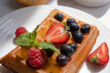 Waffles with strawberries, raspberries and blueberries
