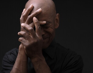 man praying to god with hands together Caribbean man praying stock photo	