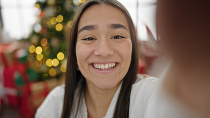 Young beautiful hispanic woman having video call celebrating christmas at home