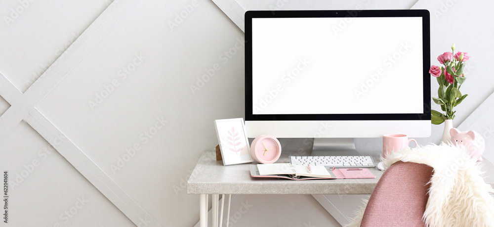 Wall mural Stylish workplace with modern computer near grey wall in room. Banner for design