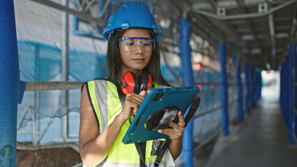 African american woman builder using touchpad at street