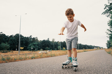 7 years old boy rides on roller skates