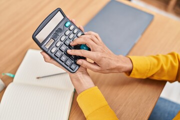Young woman business worker using calculator at office