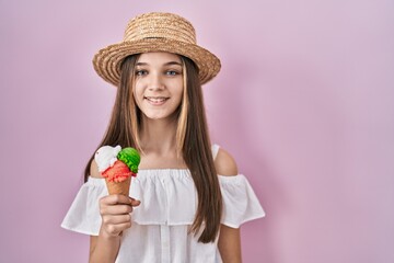 Teenager girl holding ice cream winking looking at the camera with sexy expression, cheerful and happy face.