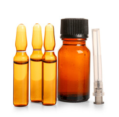 Ampules with bottle of medicines and syringe needle on white background