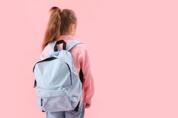 Little schoolgirl with backpack on pink background, back view