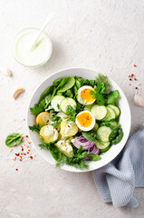 Green Buddha Bowl with Fresh Herbs and Vegetables, Healthy Balanced Meal, Bowl or Salad with Young Potatoes, Cucumber, Lettuce, Egg and Herb Dressing