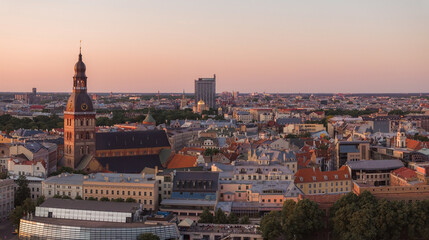 Fototapeta na wymiar RIga rooftop view panorama at sunset with urban architectures and Daugava River. Aerial view of the Riga old town at sunset.