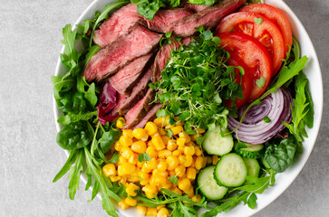Beef steak and Fresh Vegetables Buddha Bowl, Healthy Balanced Meal on Bright Background