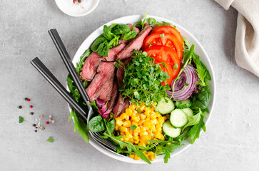 Beef steak and Fresh Vegetables Buddha Bowl, Healthy Balanced Meal on Bright Background