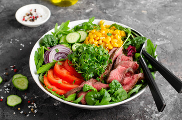 Beef steak and Fresh Vegetables Buddha Bowl, Healthy Balanced Meal on Dark Background