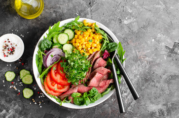 Beef steak and Fresh Vegetables Buddha Bowl, Healthy Balanced Meal on Dark Background