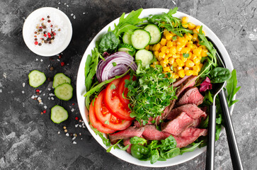 Beef steak and Fresh Vegetables Buddha Bowl, Healthy Balanced Meal on Dark Background