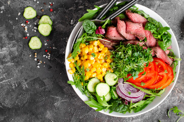 Beef steak and Fresh Vegetables Buddha Bowl, Healthy Balanced Meal on Dark Background