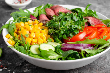 Beef steak and Fresh Vegetables Buddha Bowl, Healthy Balanced Meal on Dark Background