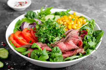 Beef steak and Fresh Vegetables Buddha Bowl, Healthy Balanced Meal on Dark Background