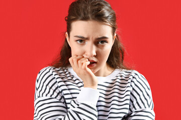 Fototapeta na wymiar Young woman having panic attack on red background
