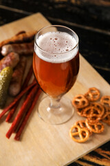 Glass of cold beer on dark wooden background. Oktoberfest celebration