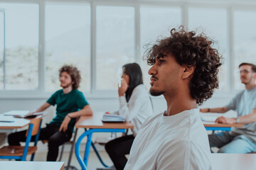 A group of diverse students engages in lively discussion as they educate themselves in a modern classroom, embracing the power of collaboration and knowledge exchange.