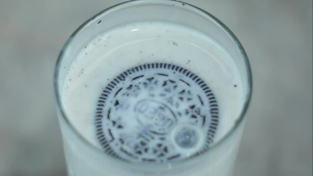 Chocolate chip cookies in a glass of milk. Tasty breakfast