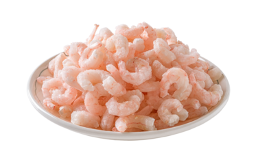 Heap of frozen boiled shrimps on a plate cutout. Plate of cooked peeled prawn tails isolated on a white background. Frozen shrimps prepared for cooking. Seafood recipe.