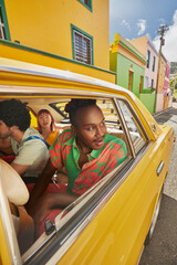 Fototapeta premium Friends arriving for vacation in vintage cab at Bo-Kaap in Cape Town