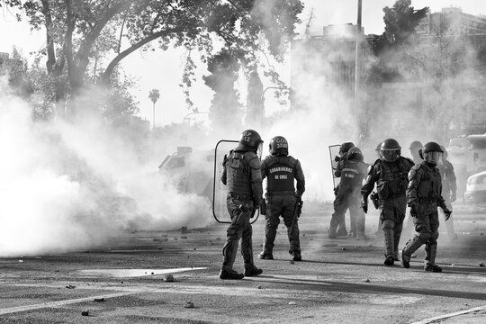 Santiago, Chile - October 18, 2022 - police surrounded by tear gas in a social demonstration