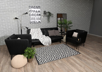 Interior of stylish living room with black sofa, armchairs and big mirror