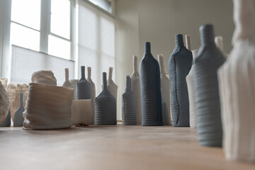 Ceramics on a table with light shining through