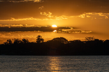 Fototapeta na wymiar Sunset on a riverbank in the Cerrado biome. Nature.