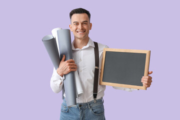 Male teacher with chalkboard and rolls of paper on lilac background