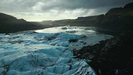 Drone shot of ice mass on frozen water, huge icy blocks floating on lake in iceland. Beautiful blue...