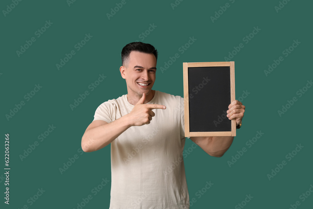 Sticker Male teacher pointing at chalkboard on green background