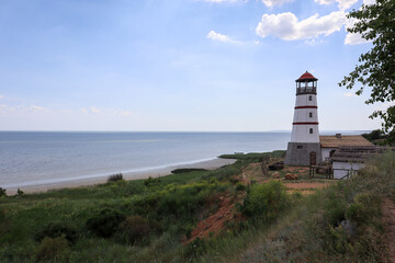 Fototapeta na wymiar the old lighthouse against the blue sky