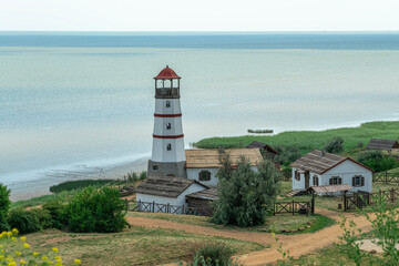 Fototapeta na wymiar the old lighthouse against the blue sky