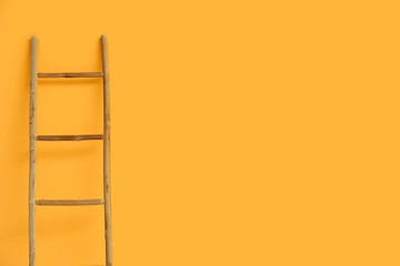 Wooden ladder near orange wall in room