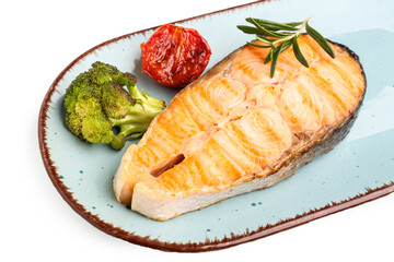Plate with tasty grilled salmon steak on white background