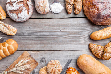 Delicious freshly baked bread on wooden background