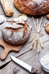 Fototapeta premium Delicious freshly baked bread on wooden background