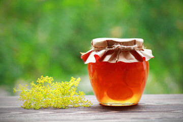 Fototapeta na wymiar Homemade fruit jam in the jar on nature background
