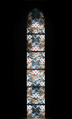 Backlit stained-glass window hand-painted with vibrant hues that shine and light up a dark room.