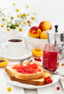 Breakfast: fresh toasts with homemade red currant marmalade, cup of coffee and fruits