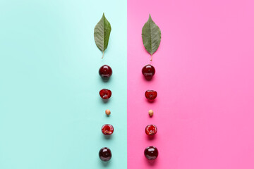 Sweet cherries with halves and leaves on colorful background