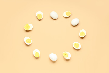 Frame made of tasty boiled eggs on orange background