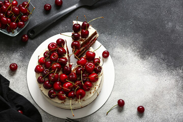 Tasty cherry cake on grunge background