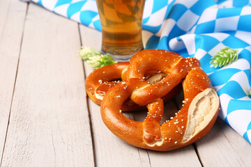 Flag of Bavaria, mug with beer and pretzels on grey wooden background