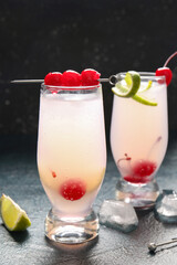 Glasses of tasty cocktail with maraschino cherries on table
