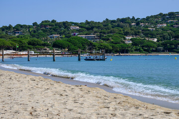 Crystal clear blue water of legendary Pampelonne beach near Saint-Tropez, summer vacation on white sandy beach of French Riviera, France