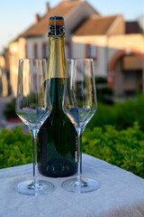 Tasting of premier cru sparkling white wine with bubbles champagne with view on old houses of...