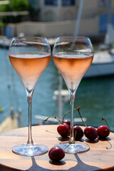 Summer party, drinking of French brut rose champagne sparkling wine in glasses in yacht harbour of Port Grimaud near Saint-Tropez, French Riviera vacation, France
